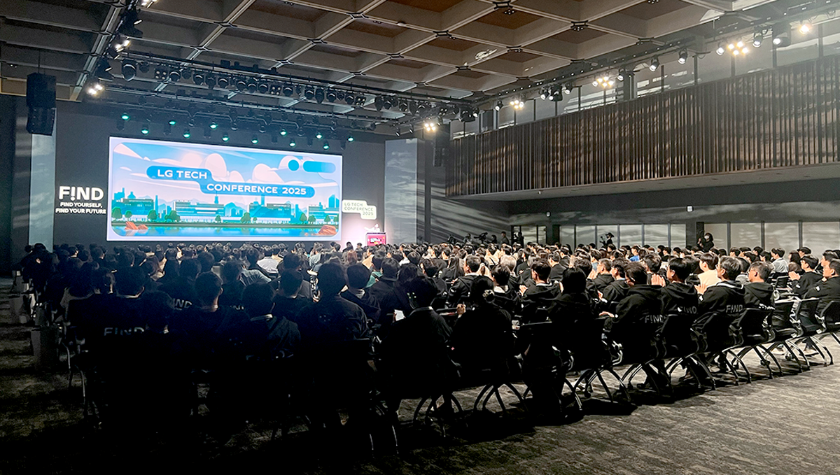 a group of people sitting in chairs in front of a large screen