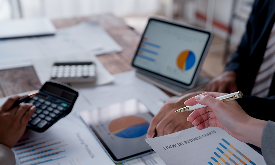 a person holding a pen over a paper