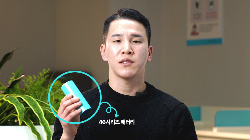 a man holding a blue tube