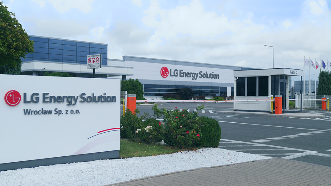 a building with a sign and a parking lot