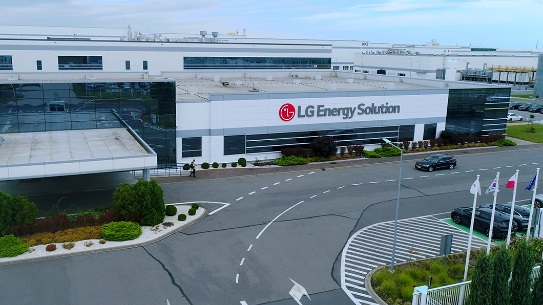 a building with a circular road and a parking lot