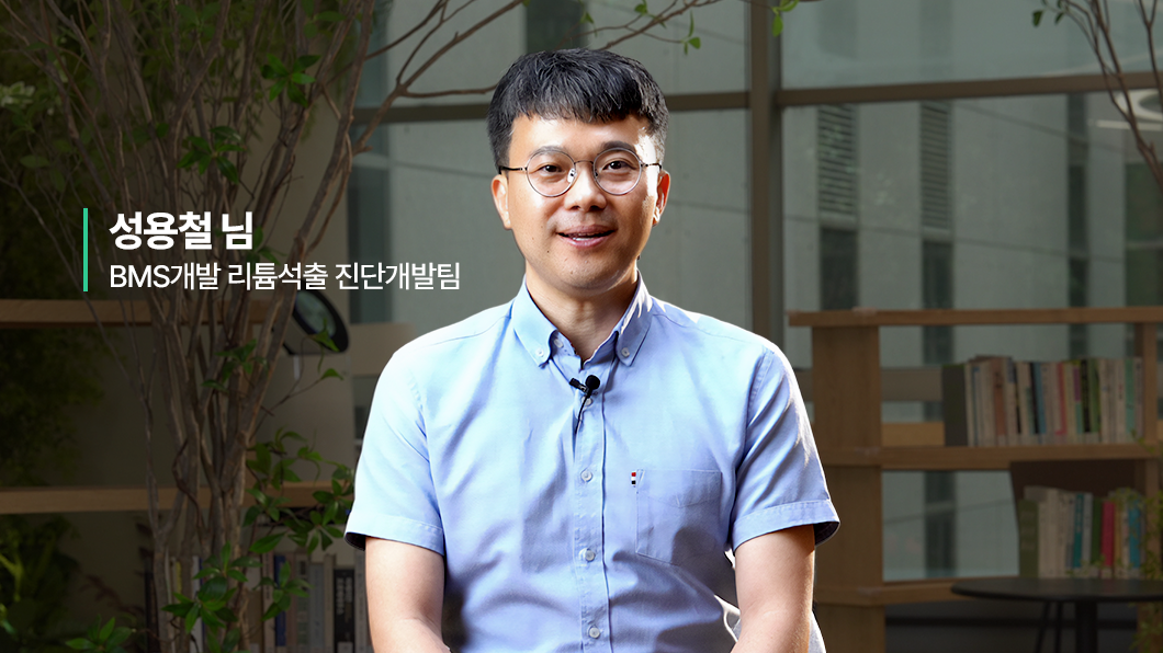 a man wearing glasses and a blue shirt