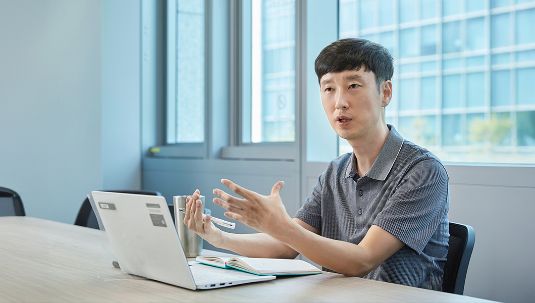 a man sitting at a table with a laptop