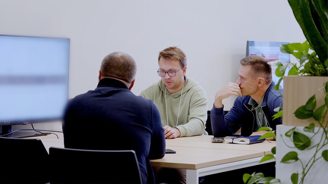 a group of men sitting at a table
