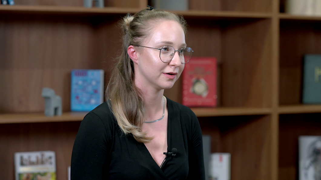 a woman wearing glasses and a black shirt